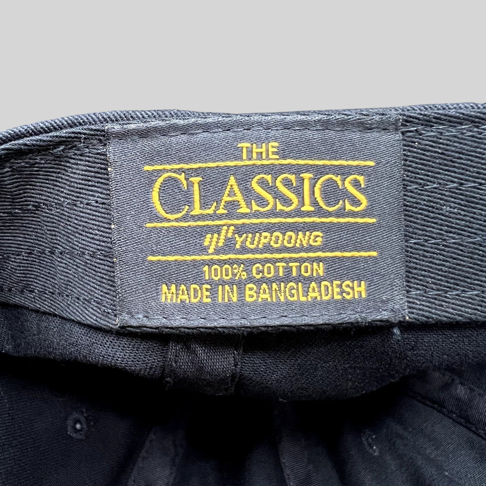 Raree Finds black cotton Classics by Yupoong hat interior label with yellow embroidery