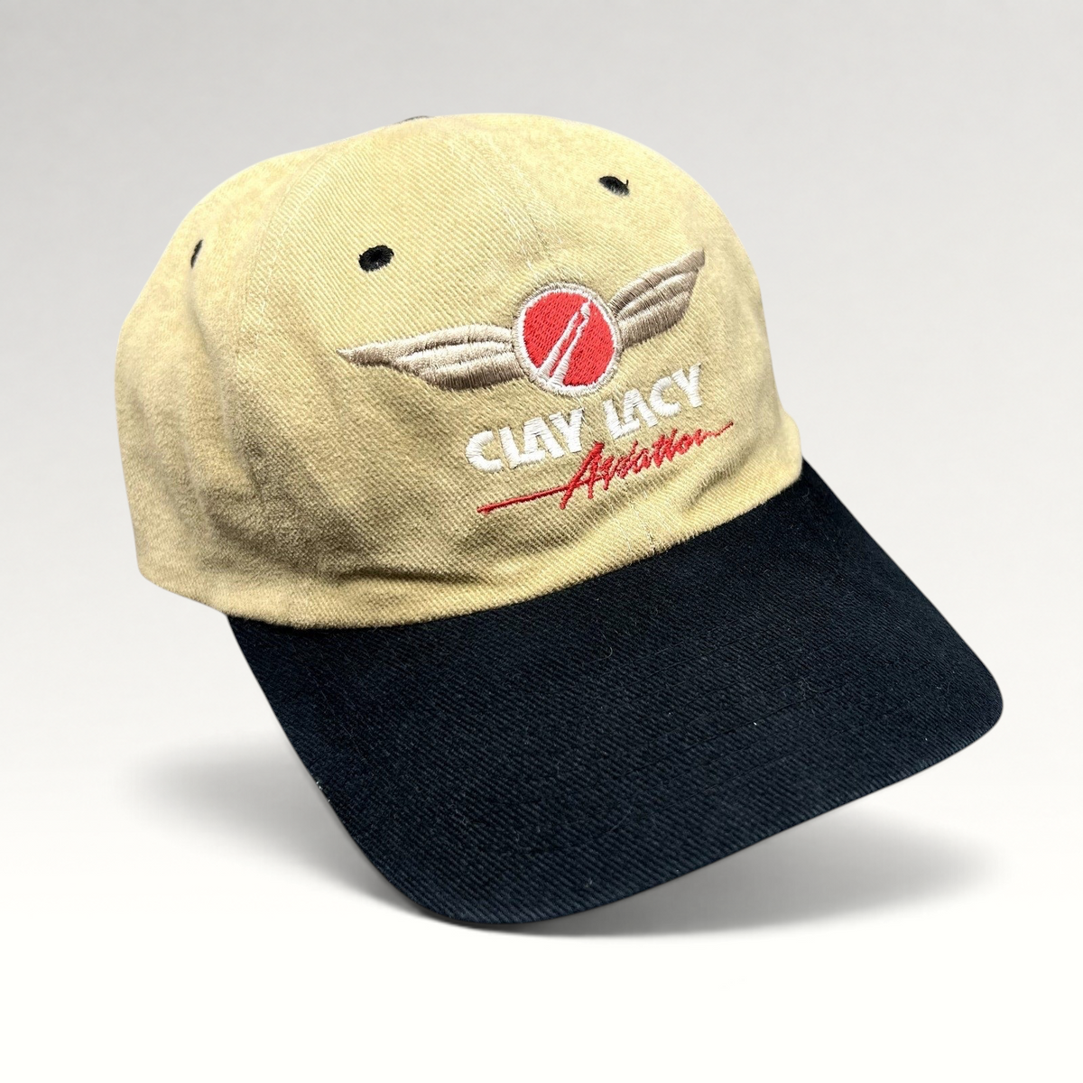Raree Finds vintage Clay Lacy Aviation cotton strapback cap in tan with a black brim and embroidered winged logo.
