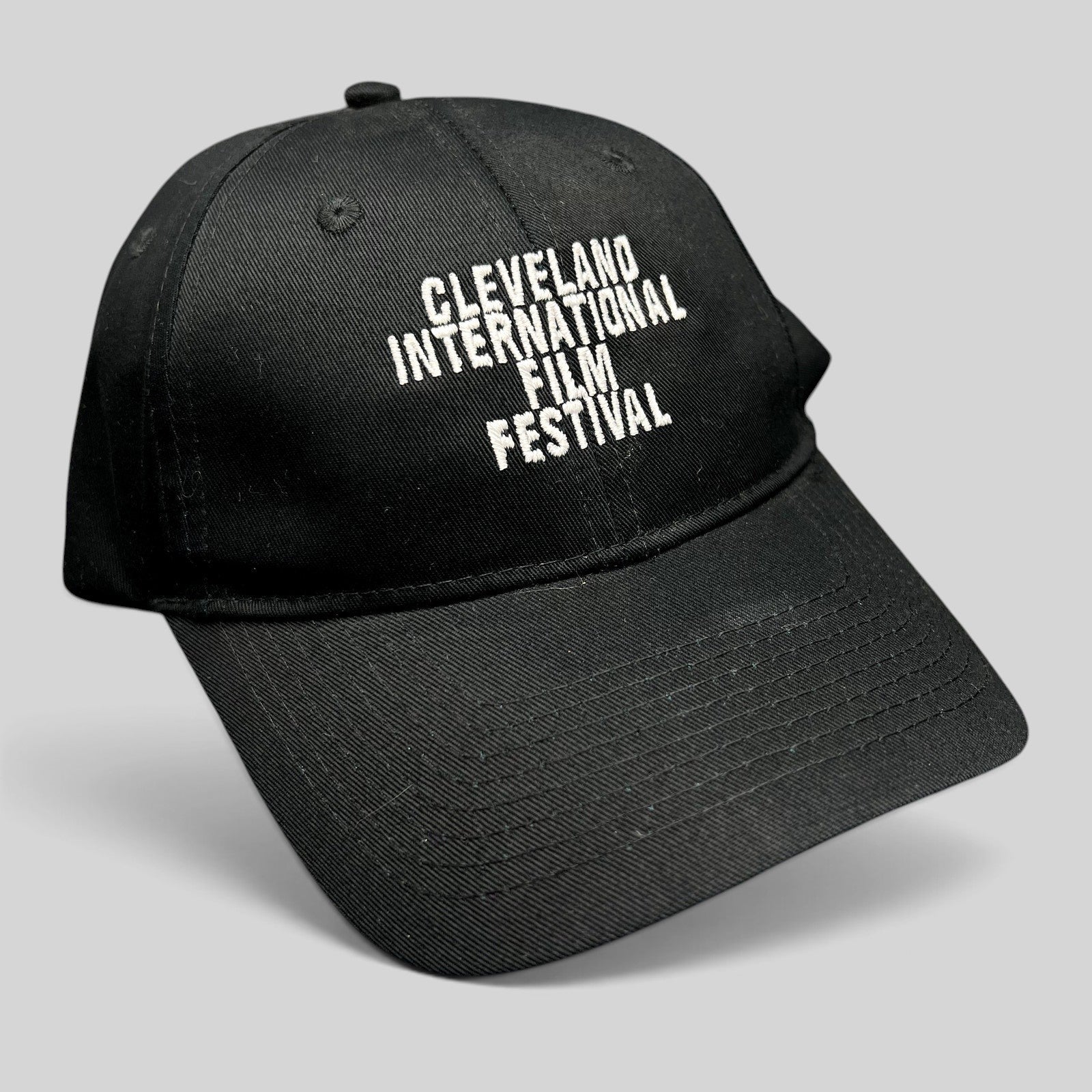 Raree Finds black strapback hat with white embroidered Cleveland International Film Festival lettering on the front