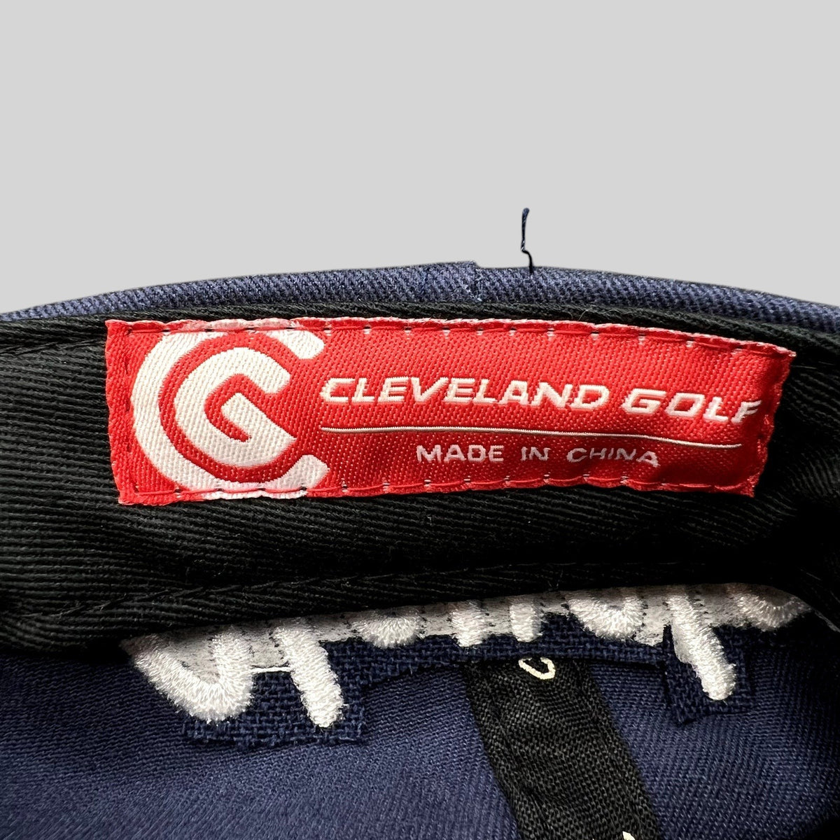 Raree Finds navy blue Cleveland Golf hat interior red brand label with white logo and text