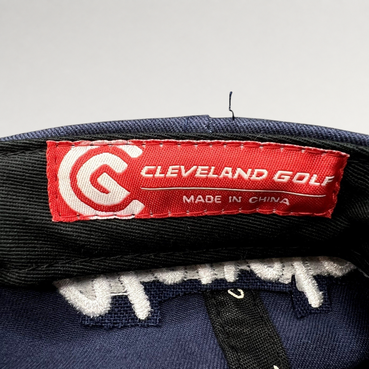 Raree Finds navy blue Cleveland Golf hat interior red brand label with white logo and text