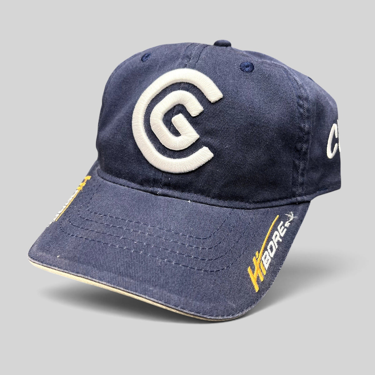 Raree Finds navy blue cotton twill Cleveland Golf strapback hat with raised white CG logo and HiBore brim embroidery.