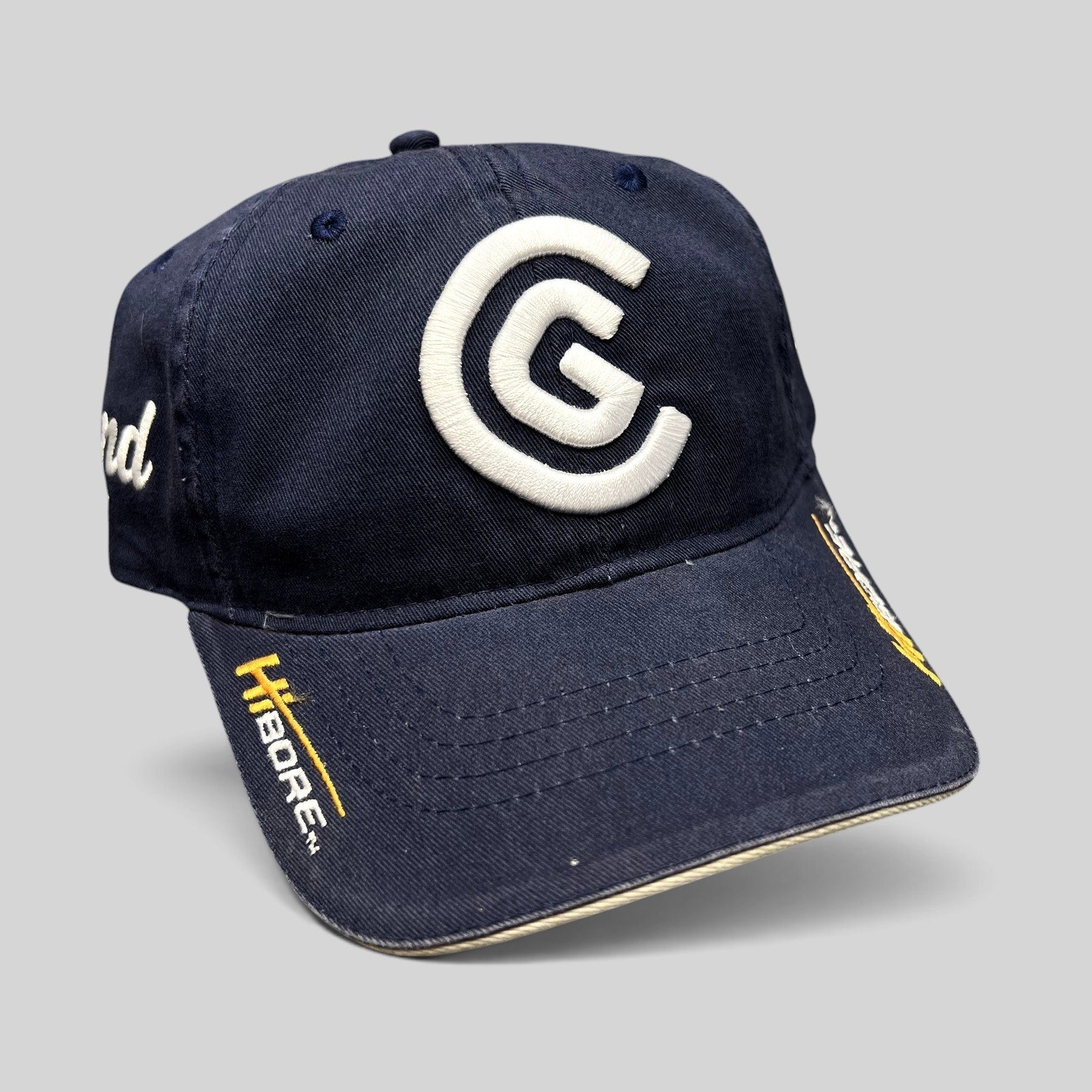 Raree Finds navy blue cotton twill Cleveland Golf strapback hat with raised white CG logo and HiBore brim embroidery