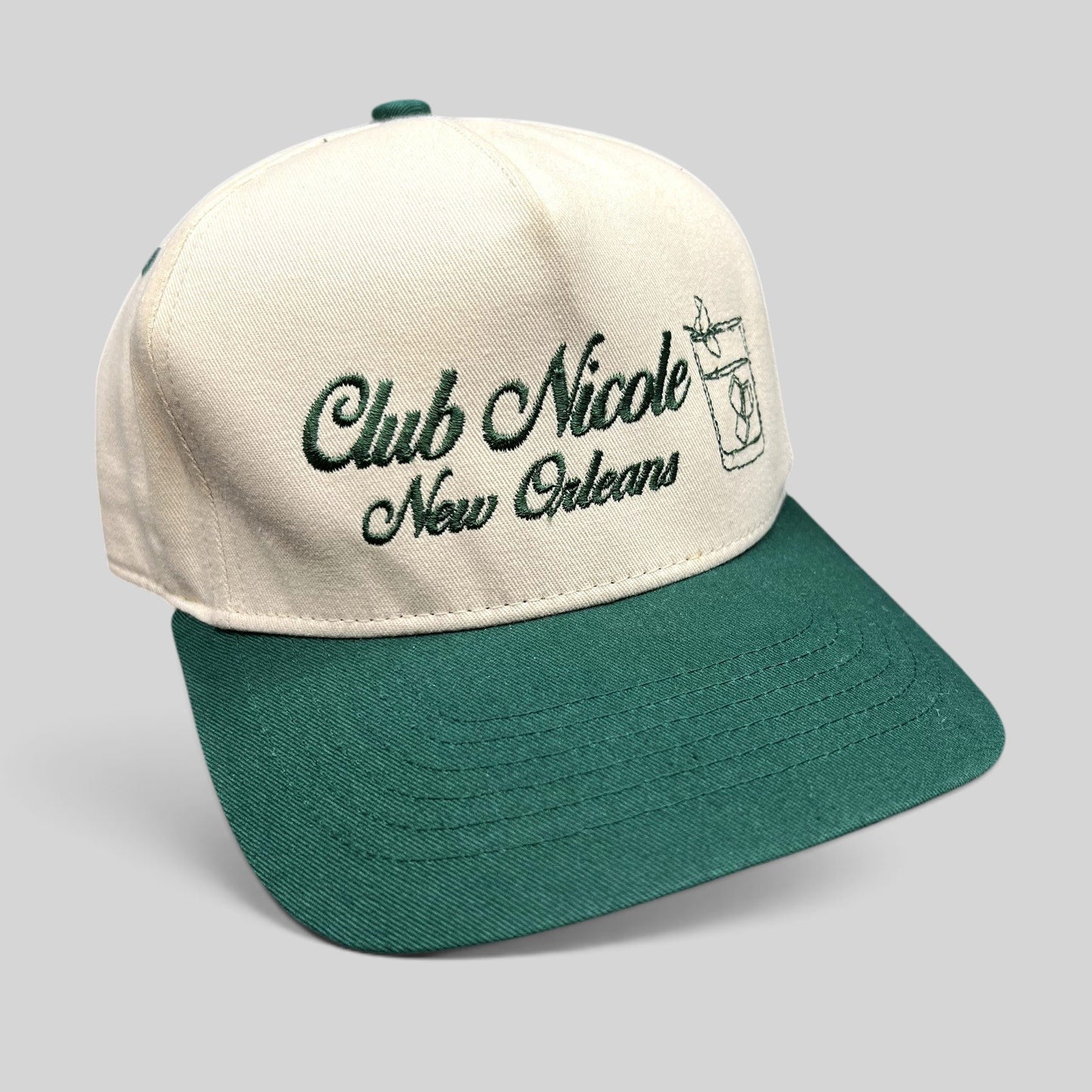 Raree Finds vintage Club Nicole New Orleans snapback hat in cream cotton with green brim and embroidered script logo.