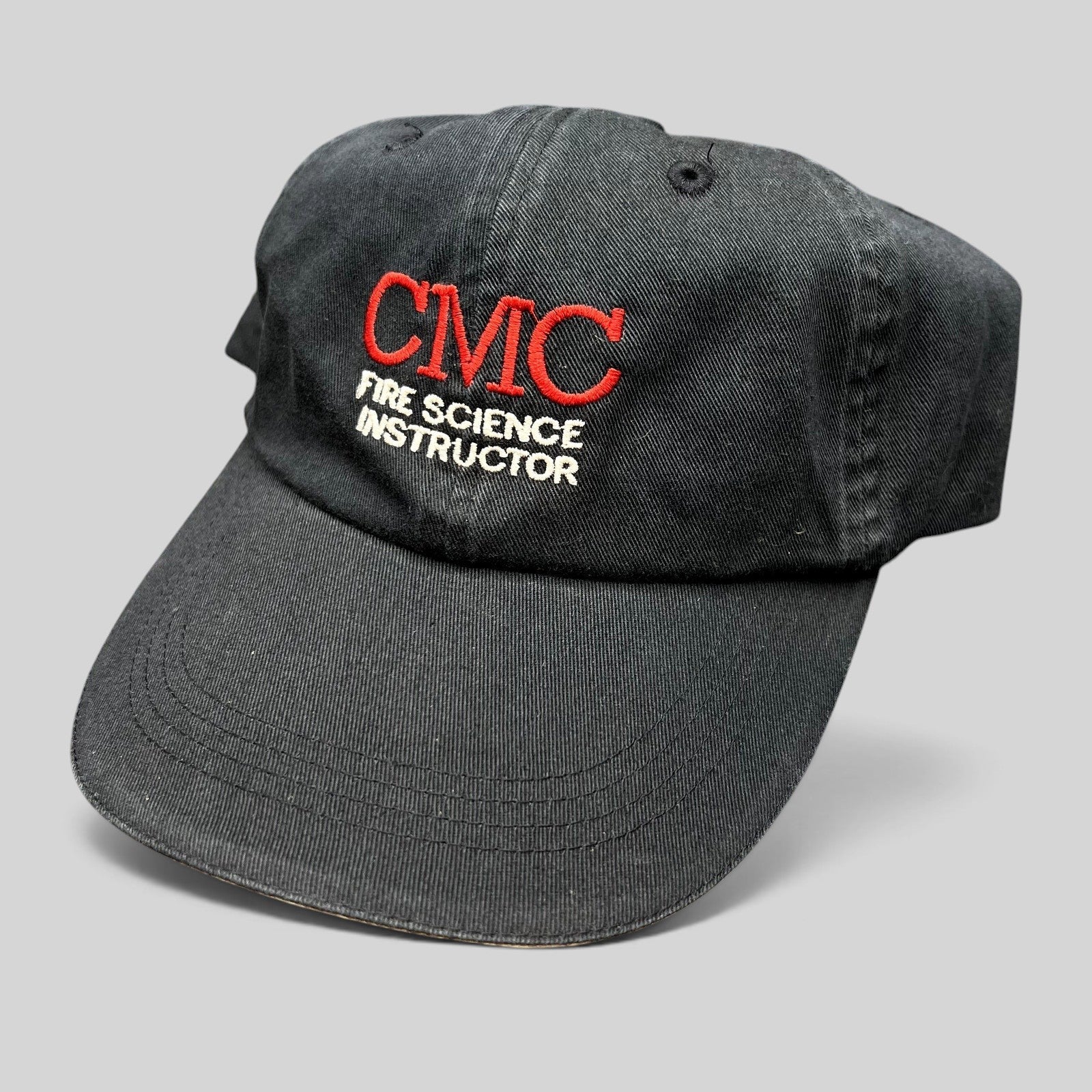 Raree Finds black cotton strapback hat featuring CMC Fire Science Instructor embroidery in red and white thread