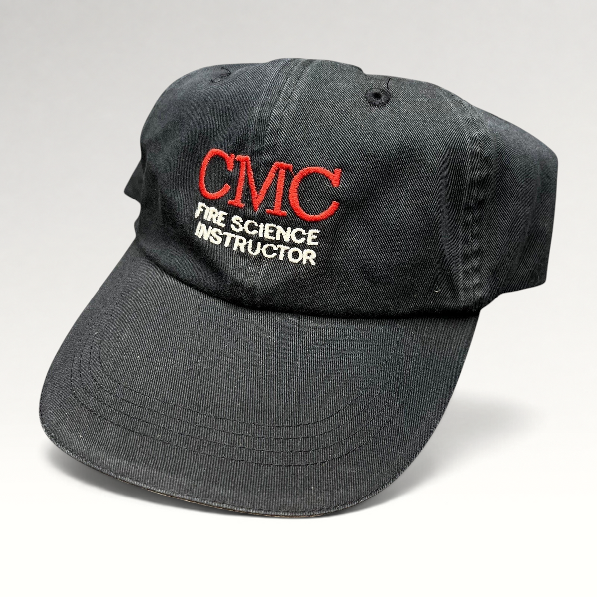 Raree Finds black cotton strapback hat with CMC Fire Science Instructor embroidery in red and white