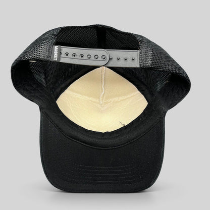 Raree Finds Coachella x Market black and white trucker hat showing the interior mesh lining and snapback closure