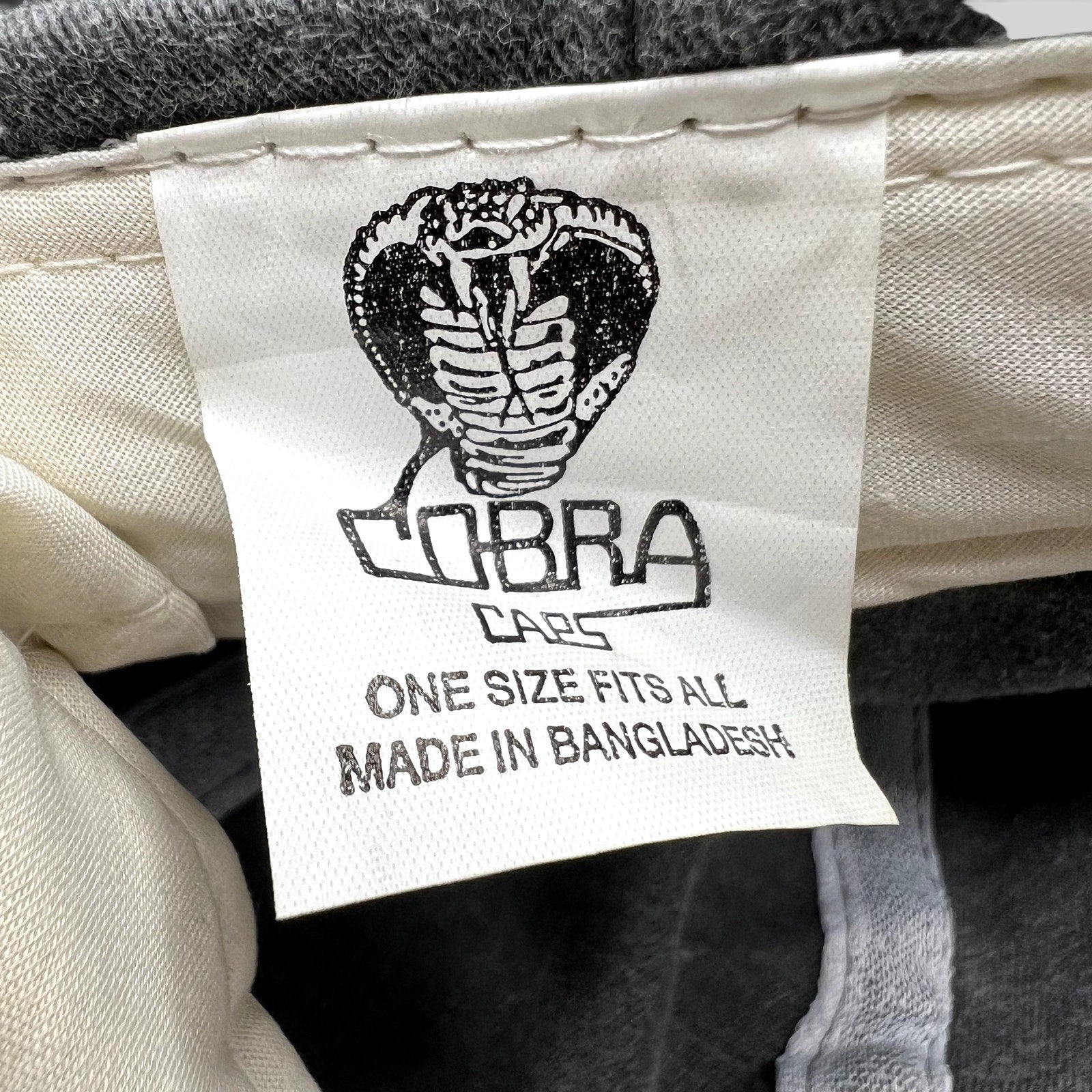 Raree Finds Cobra Caps vintage hat interior tag featuring a cobra logo and manufacturing details