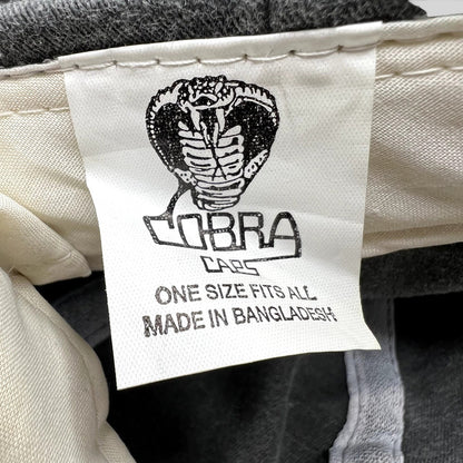 Raree Finds Cobra Caps vintage hat interior tag featuring a cobra logo and manufacturing details