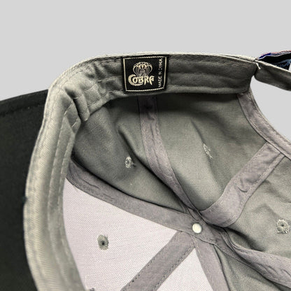 Raree Finds Cobra Headwear interior tag on a black and gray structured Toyota Tundra promotional cap