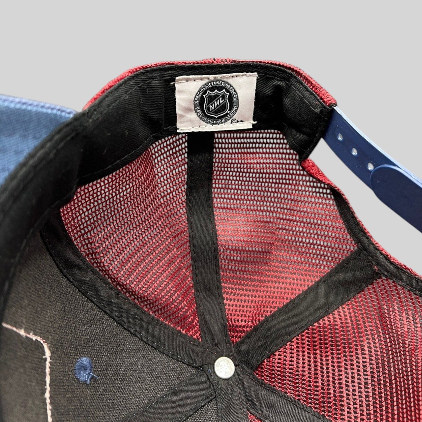 Raree Finds Colorado Avalanche NHL trucker hat interior showing official licensed product tag and maroon mesh back