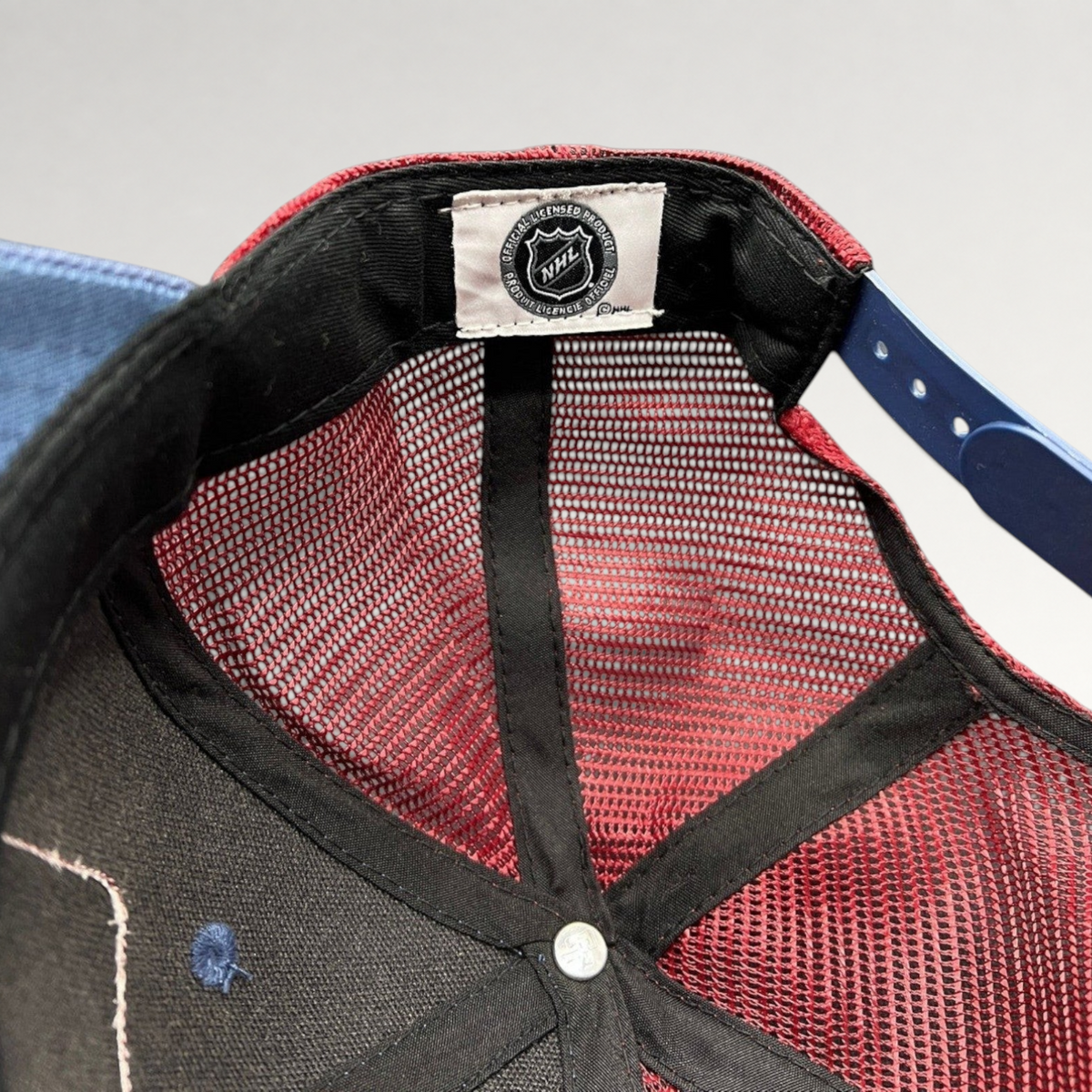 Raree Finds Colorado Avalanche NHL trucker hat interior showing official licensed product tag and maroon mesh back