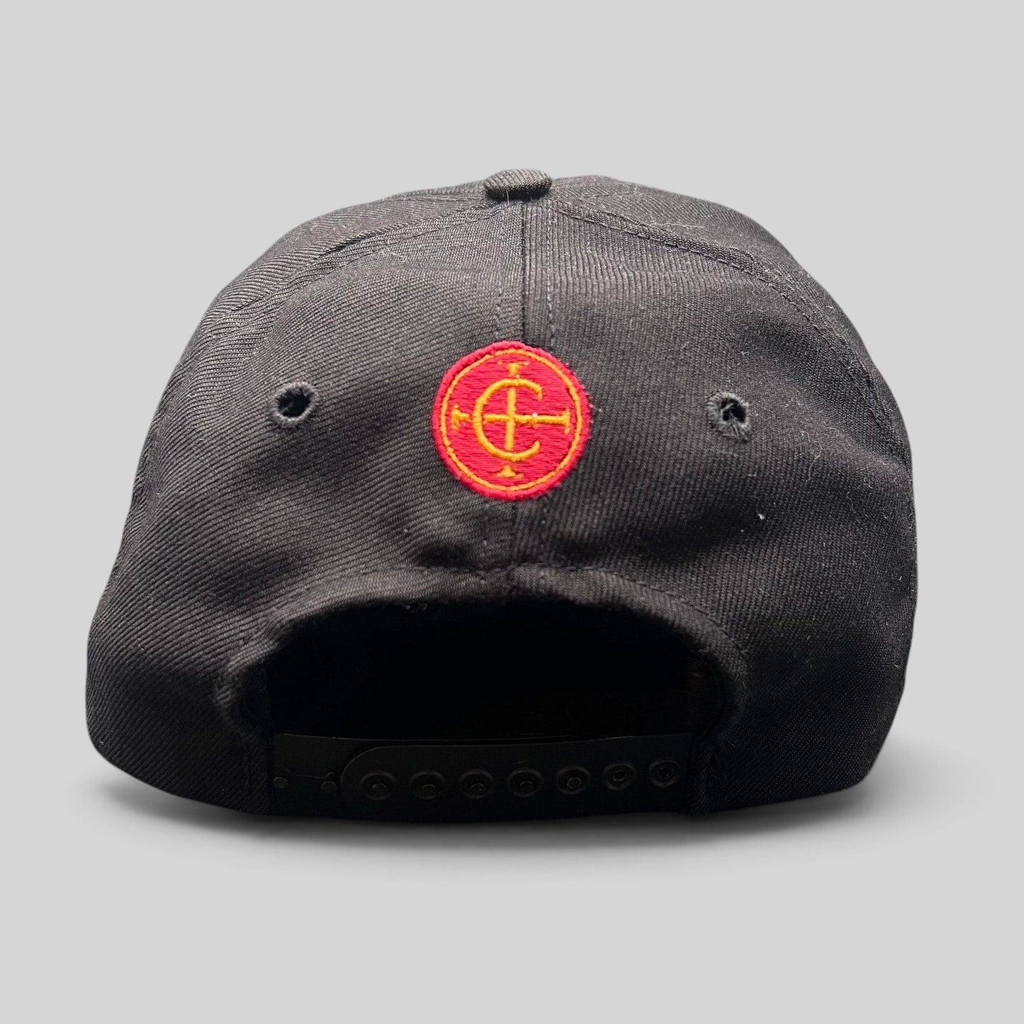 Raree Finds vintage Columbia Sportswear black snapback hat featuring a red and yellow embroidered circular emblem