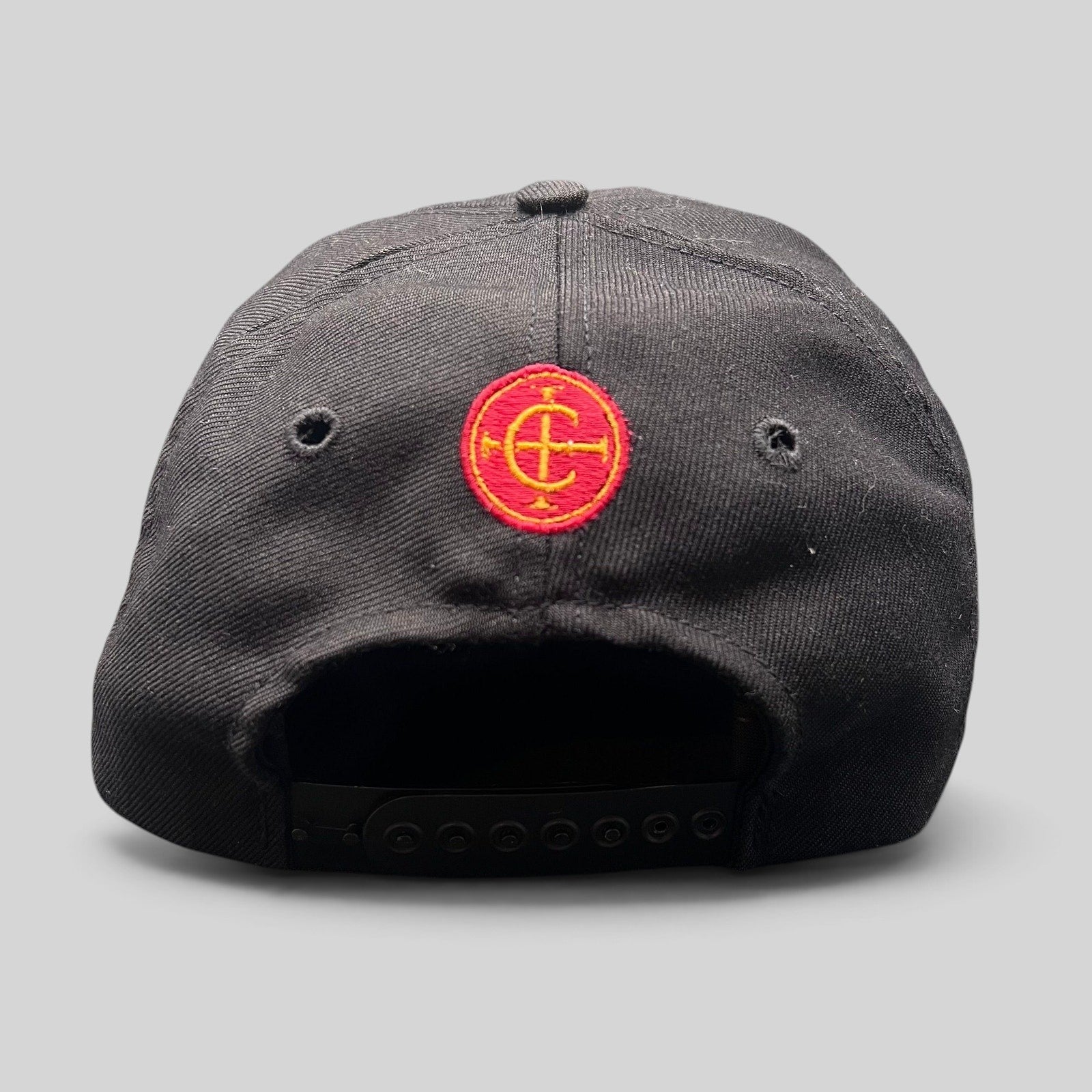 Raree Finds vintage Columbia Sportswear black snapback hat featuring a red and yellow embroidered circular emblem