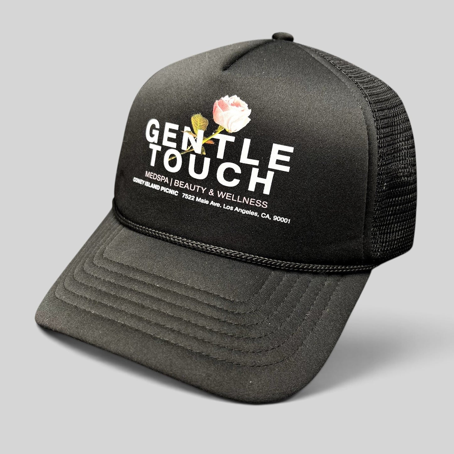 Raree Finds Coney Island Picnic black foam trucker hat with Gentle Touch MedSpa rose graphic and mesh back