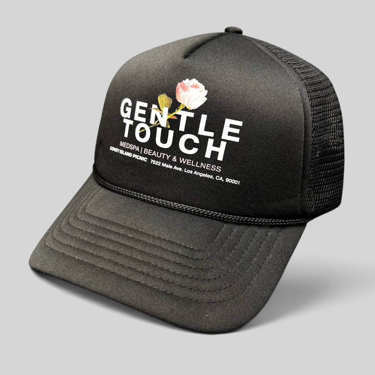 Raree Finds Coney Island Picnic black foam trucker hat with Gentle Touch MedSpa rose graphic and mesh back