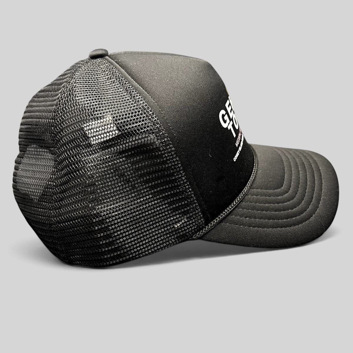 Raree Finds Coney Island Picnic black foam trucker hat with Gentle Touch MedSpa graphic and mesh back, side view.