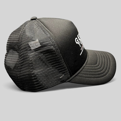 Raree Finds Coney Island Picnic black foam trucker hat with Gentle Touch MedSpa graphic and mesh back, side view.