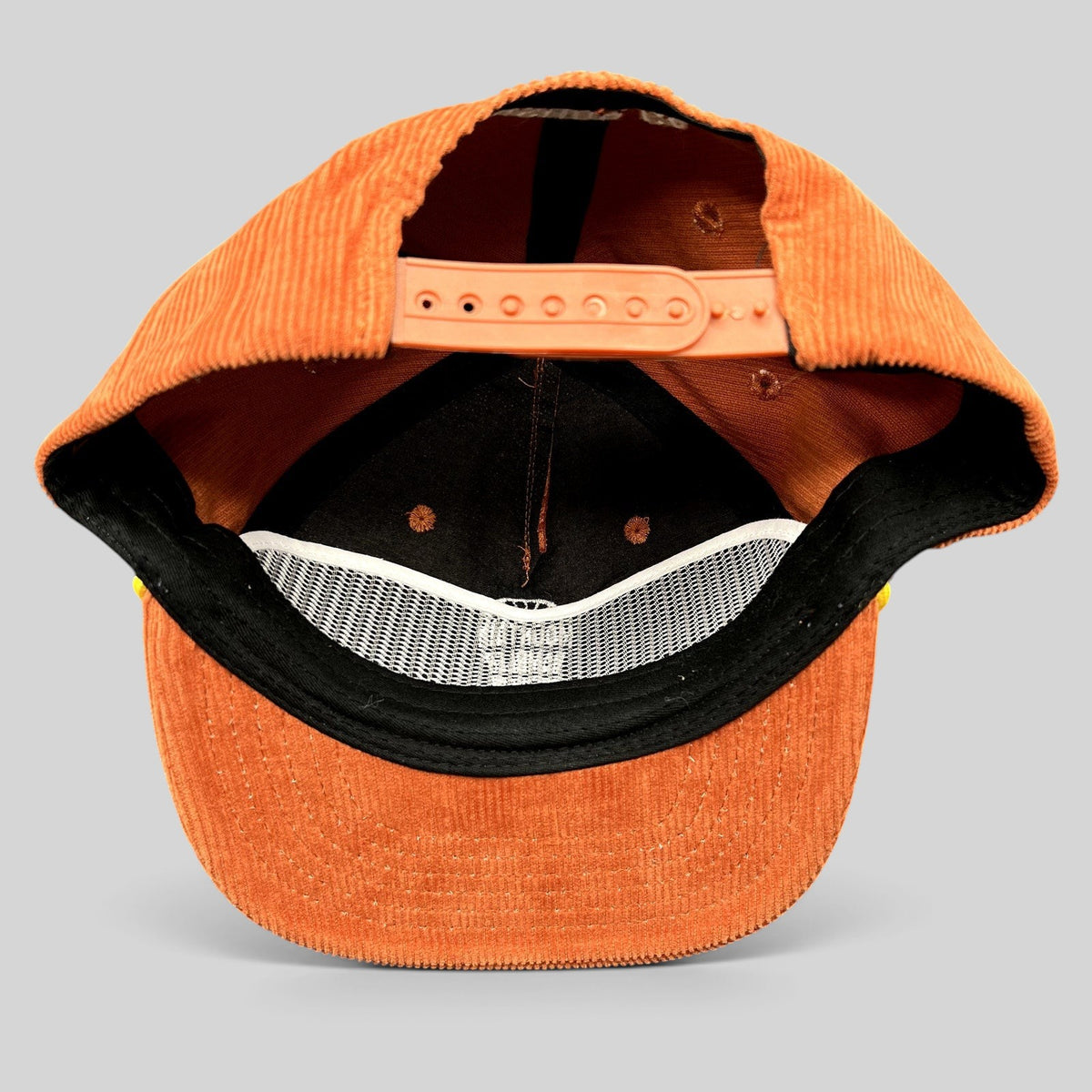 Raree Finds burnt orange corduroy snapback hat interior view showing adjustable strap and structured crown