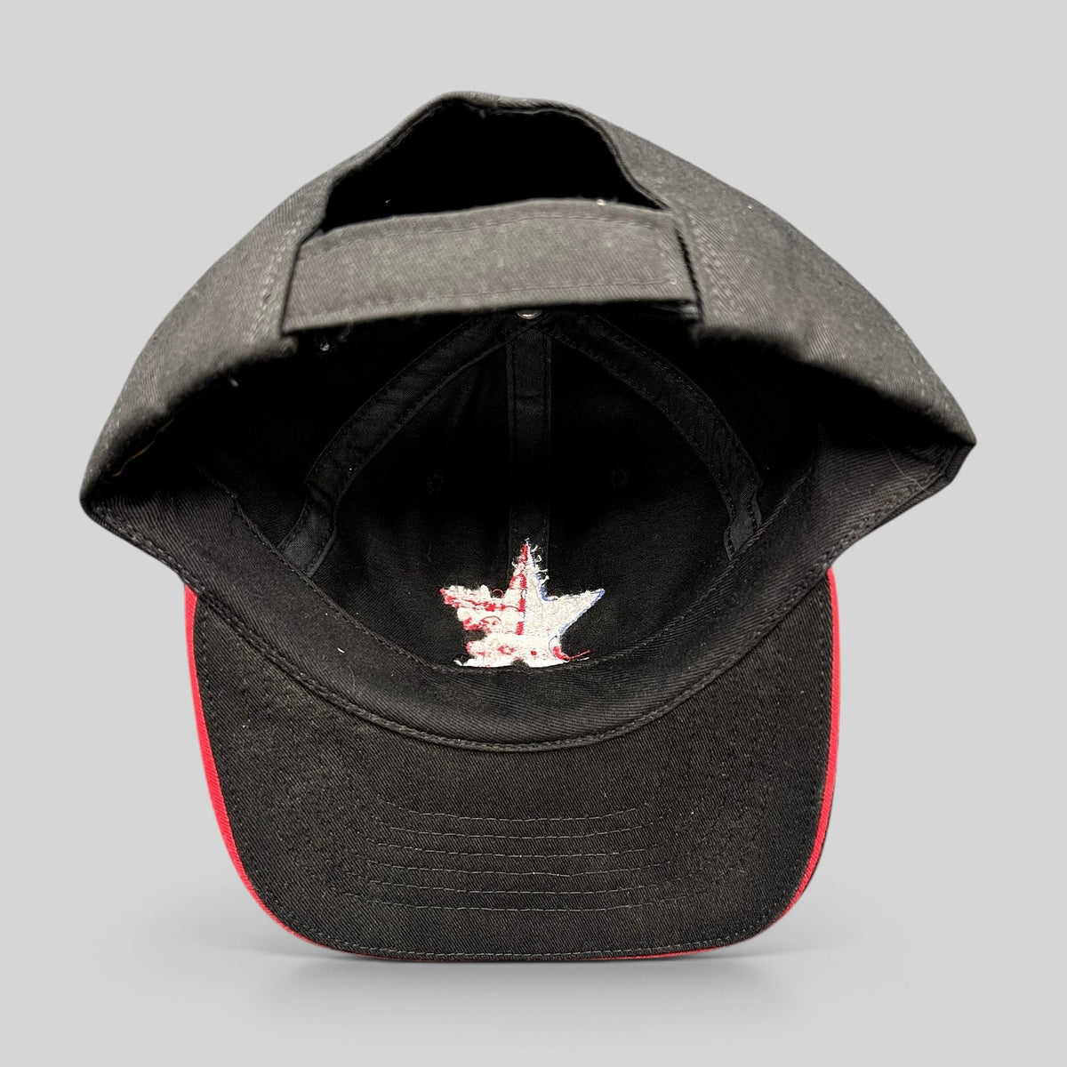 Raree Finds Corps Classics black strapback hat with interior American flag star embroidery and red sandwich brim