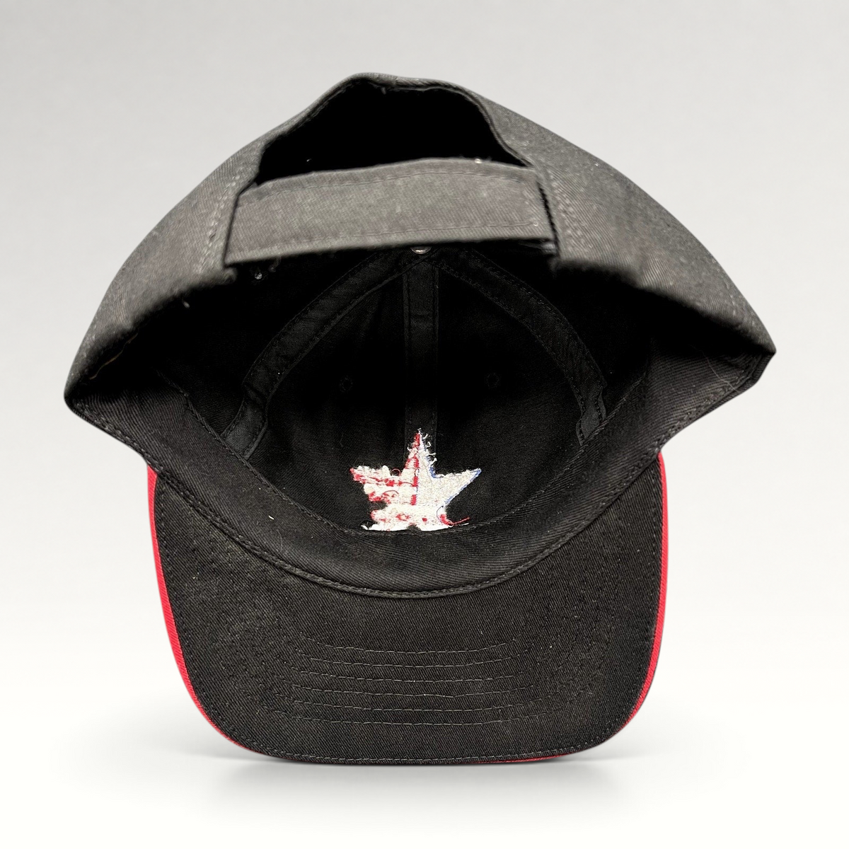 Raree Finds Corps Classics black strapback hat with interior American flag star embroidery and red sandwich brim