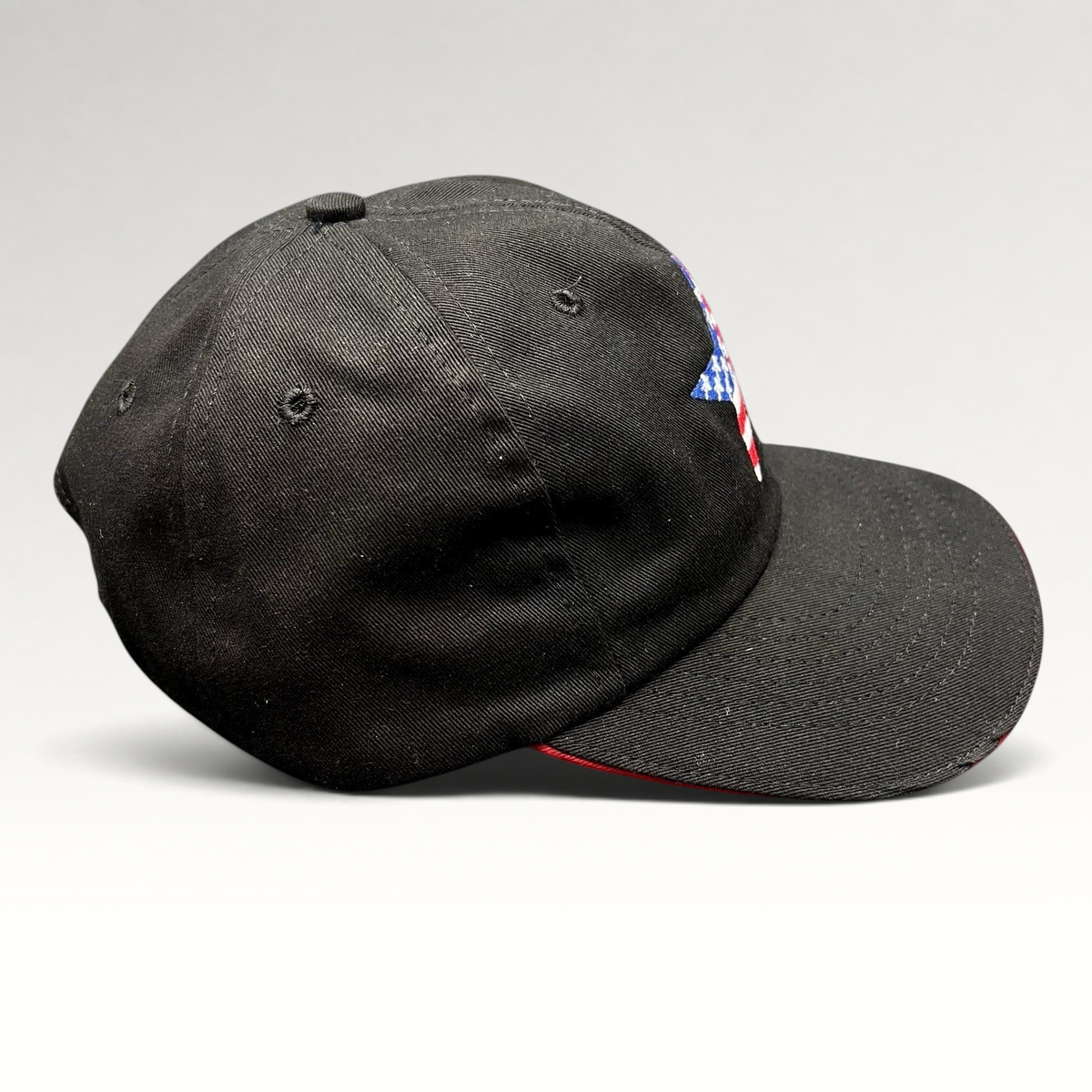 Raree Finds Corps Classics black strapback hat with patriotic American flag star embroidery and red sandwich brim.