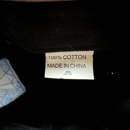 Raree Finds 100 percent cotton fabric care label inside a black hat with a blue embroidered diamond logo detail