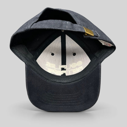 Raree Finds navy cotton strapback hat from the 2009 film Couples Retreat with an adjustable brass clasp closure.