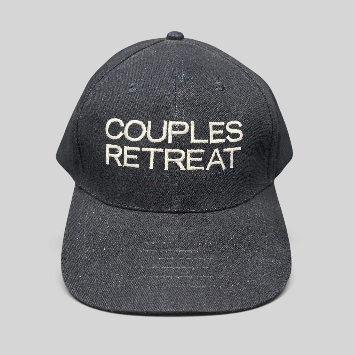 Raree Finds navy cotton strapback hat with white Couples Retreat film embroidery and adjustable brass clasp closure.