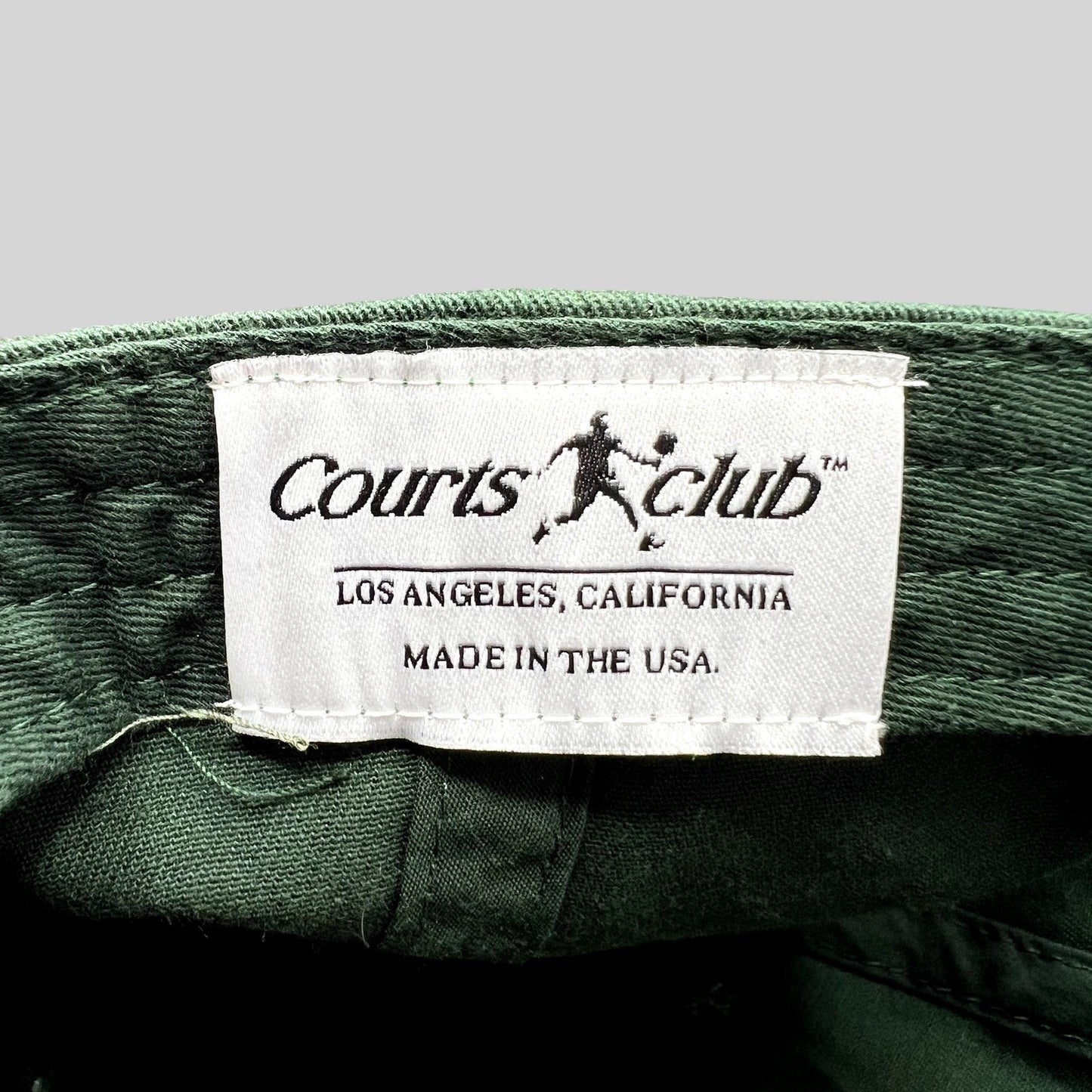 Raree Finds Courts Club Los Angeles hat interior label showing brand name and Made in the USA text on green fabric