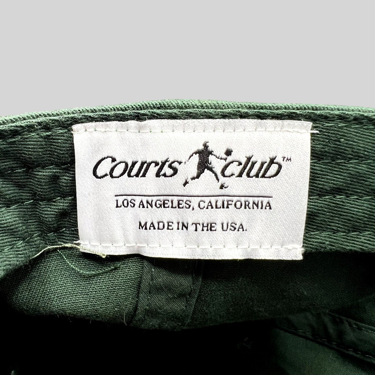 Raree Finds Courts Club Los Angeles hat interior label showing brand name and Made in the USA text on green fabric