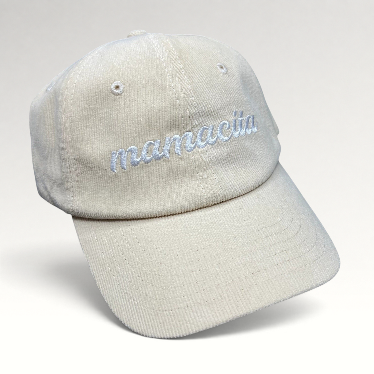 Raree Finds cream corduroy strapback hat with white Mamacita embroidery in a minimalist low-profile streetwear style.