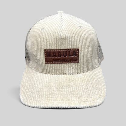 Raree Finds cream corduroy trucker hat with a brown leather Mabula Game Lodge patch and breathable mesh back panels.