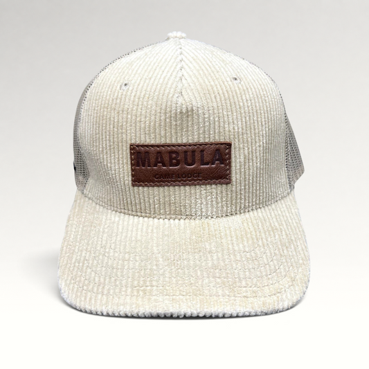 Raree Finds cream corduroy trucker hat with a brown leather Mabula Game Lodge patch and breathable mesh back panels.