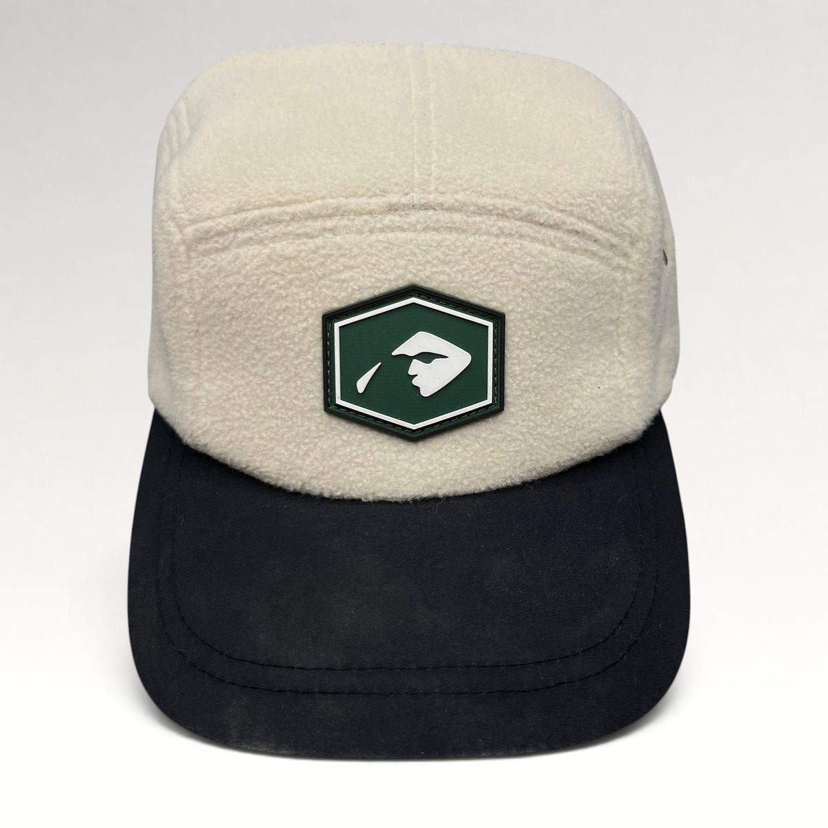 Raree Finds Baldface cream fleece strapback hat with a black bill and green rubber logo patch on the front