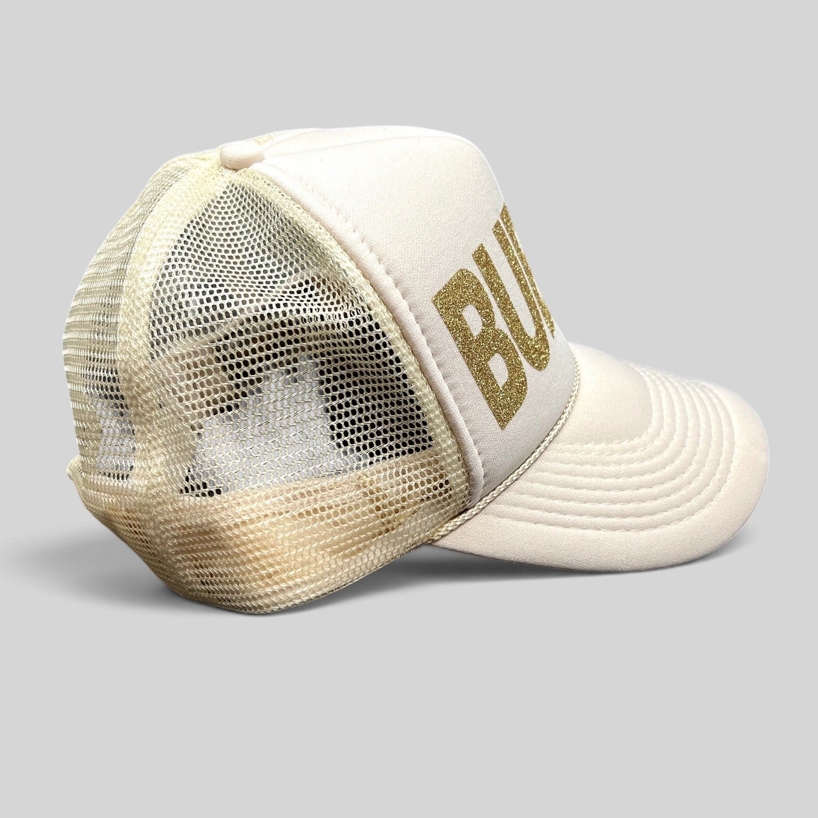 Raree Finds cream and off-white trucker hat with gold glitter BUBBLY lettering and breathable mesh back panel.