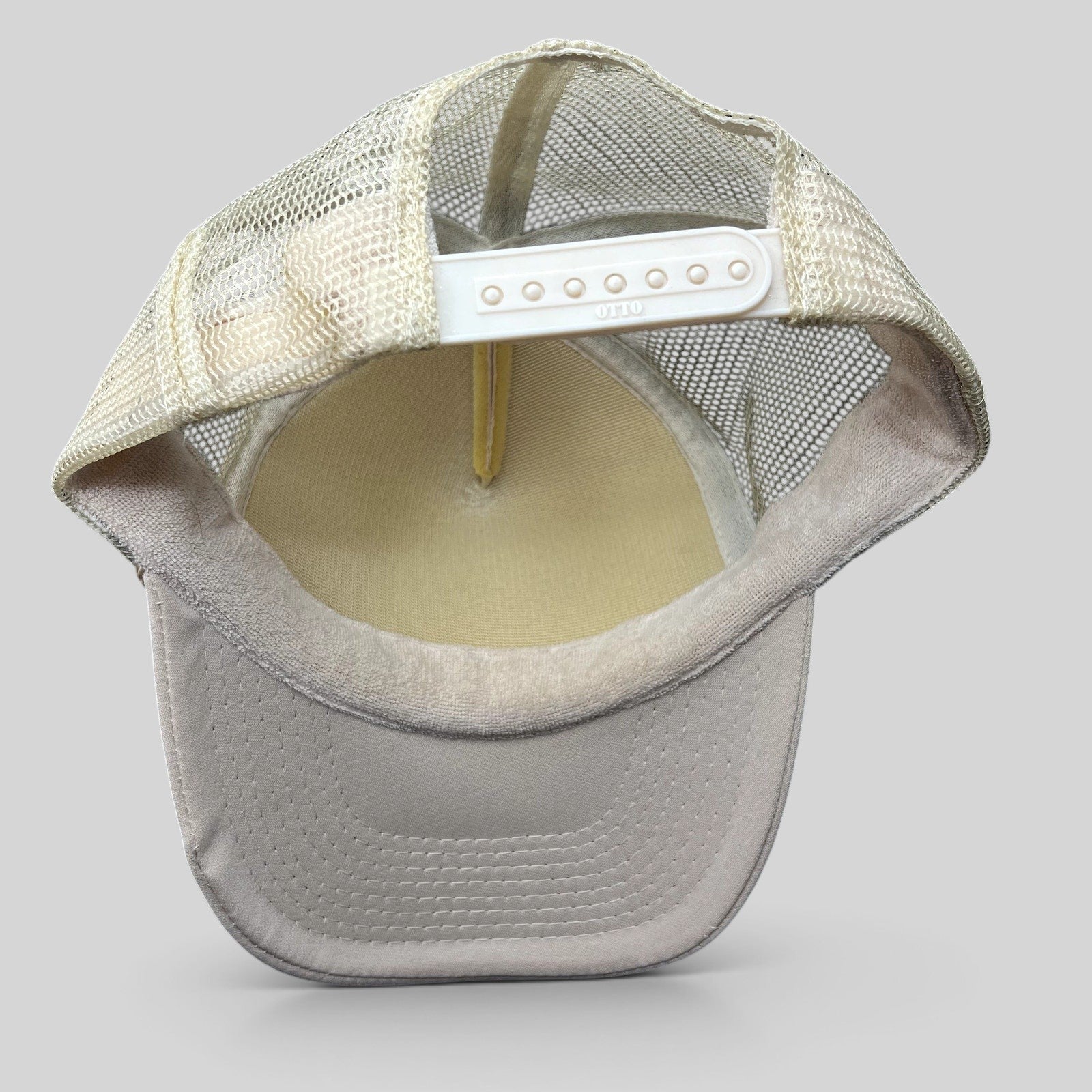Rear view of Raree Finds NBRHD Neighborhood Laguna cream mesh trucker hat with adjustable white plastic snapback