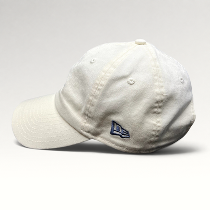 Raree Finds cream New Era strapback hat with side embroidered logo, unstructured cotton crown, and curved brim.