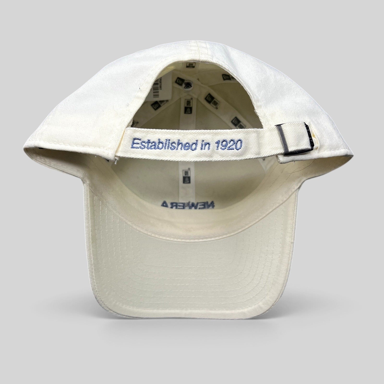 Raree Finds cream cotton New Era strapback hat with Established in 1920 embroidery on the rear adjustable strap
