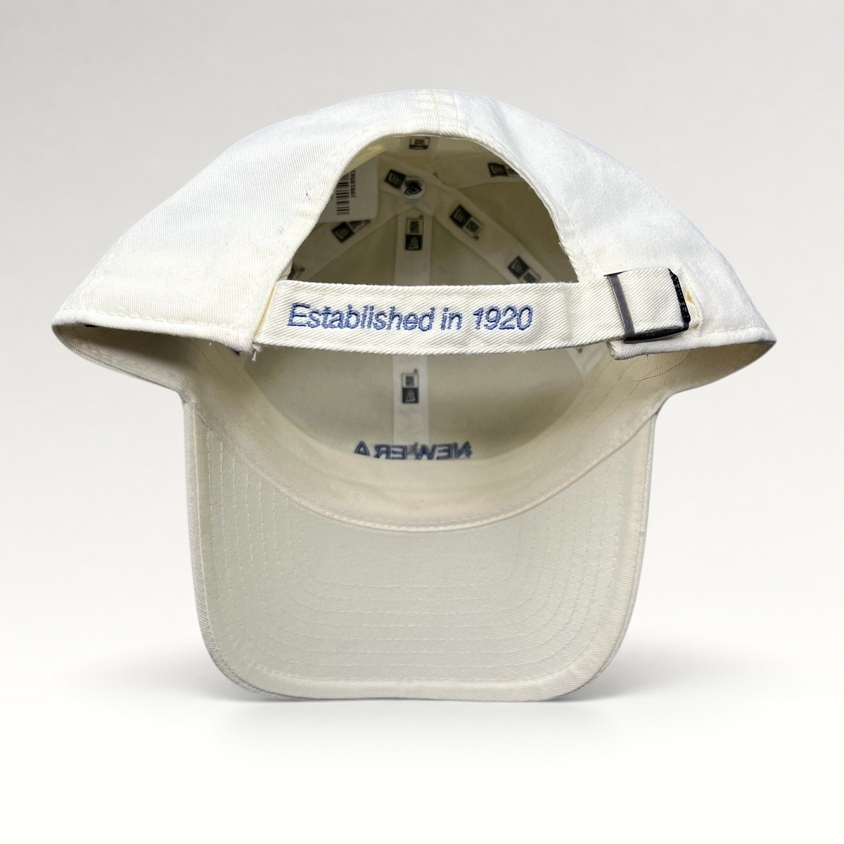 Raree Finds cream cotton New Era strapback hat with Established in 1920 embroidery on the rear adjustable strap