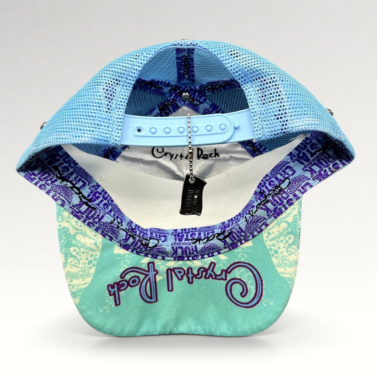 Raree Finds Crystal Rock by Christian Audigier teal mesh trucker hat with branded interior tape and metal tag