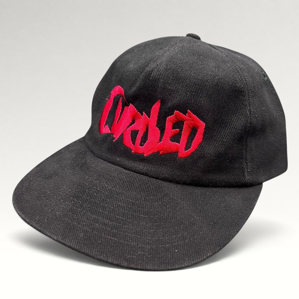 Raree Finds black cotton snapback hat with red embroidered Curdled metal band logo on the front panel.