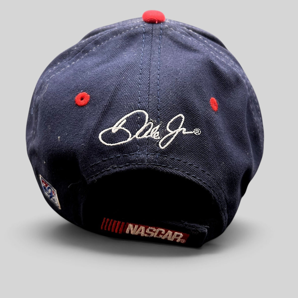Raree Finds navy blue NASCAR hat with Dale Jr. signature embroidered on the back and red eyelet accents.