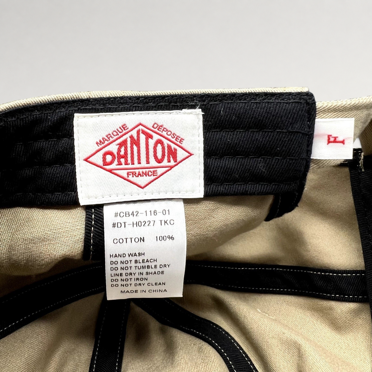 Raree Finds Danton khaki cotton twill cap interior showing the brand logo label and care instructions tag