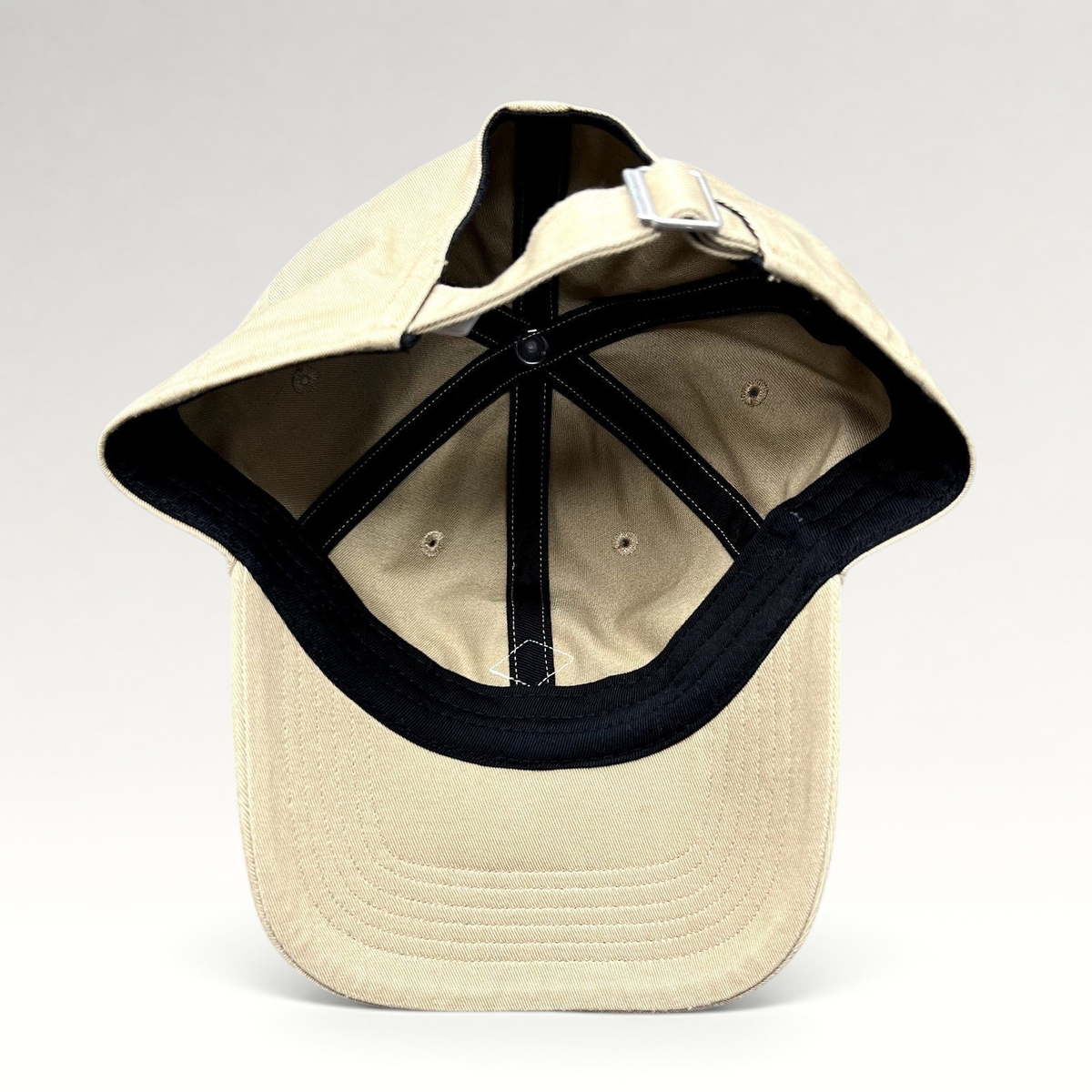 Raree Finds Danton khaki cotton twill strapback hat showing the interior six-panel construction and metal buckle