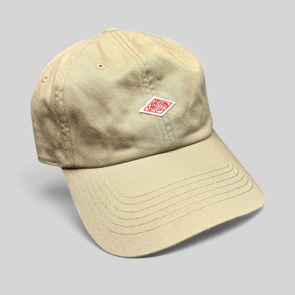 Raree Finds Danton khaki cotton twill strapback hat with an embroidered red diamond logo on a six-panel cap.