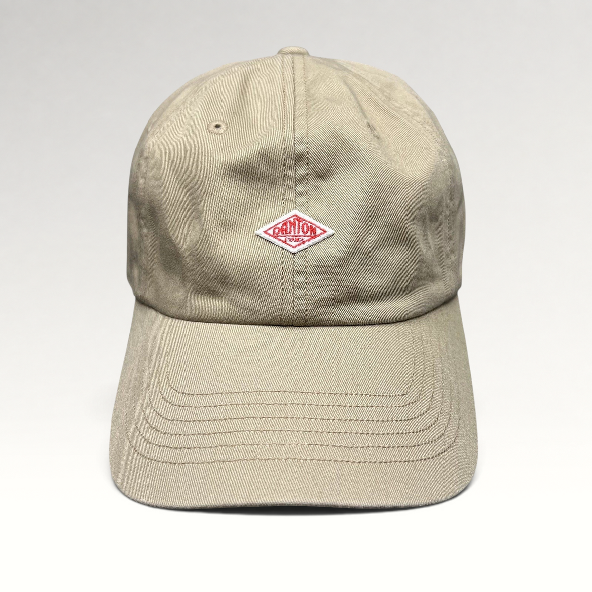 Raree Finds Danton khaki cotton twill strapback hat with an embroidered red diamond logo on the front