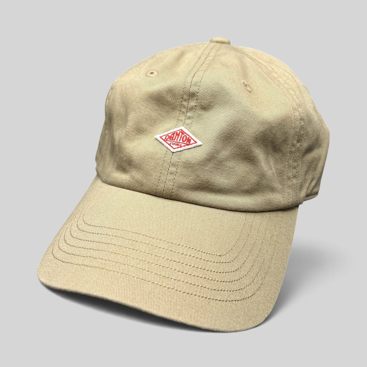 Raree Finds Danton khaki cotton twill strapback hat with a red diamond logo embroidery on the front