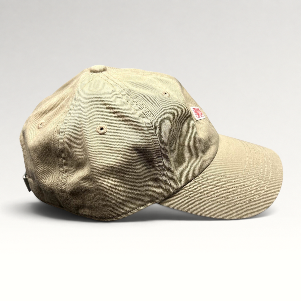 Raree Finds khaki Danton cotton twill strapback hat with red diamond logo embroidery and six-panel construction.