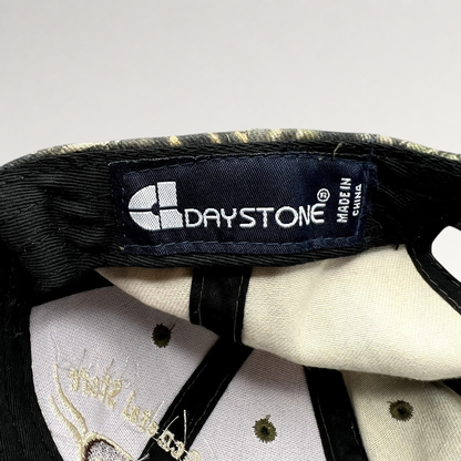 Raree Finds Daystone brand label inside a woodland camouflage strapback hat with embroidered interior details